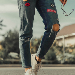 111F patched jeans with fancy badges